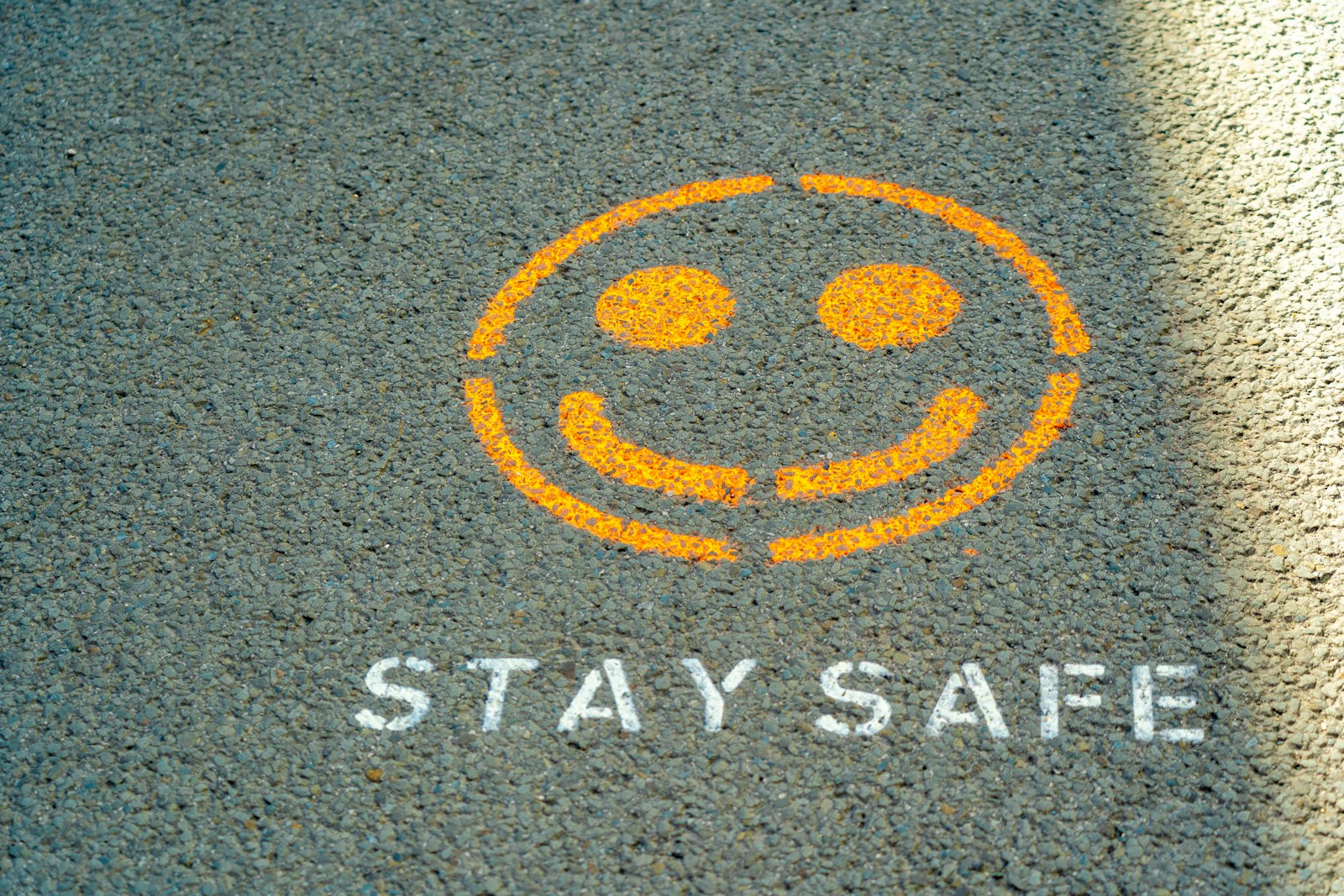 black and gray smiley face with stay safe written